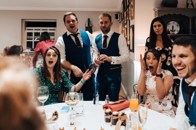 Widbrook Grange wedding guests shocked and delighted by some magic tricks throwing their hands in the air